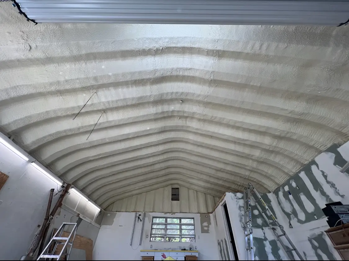 Spray polyurethane foam applied to the underside of a metal roof deck in Havelock